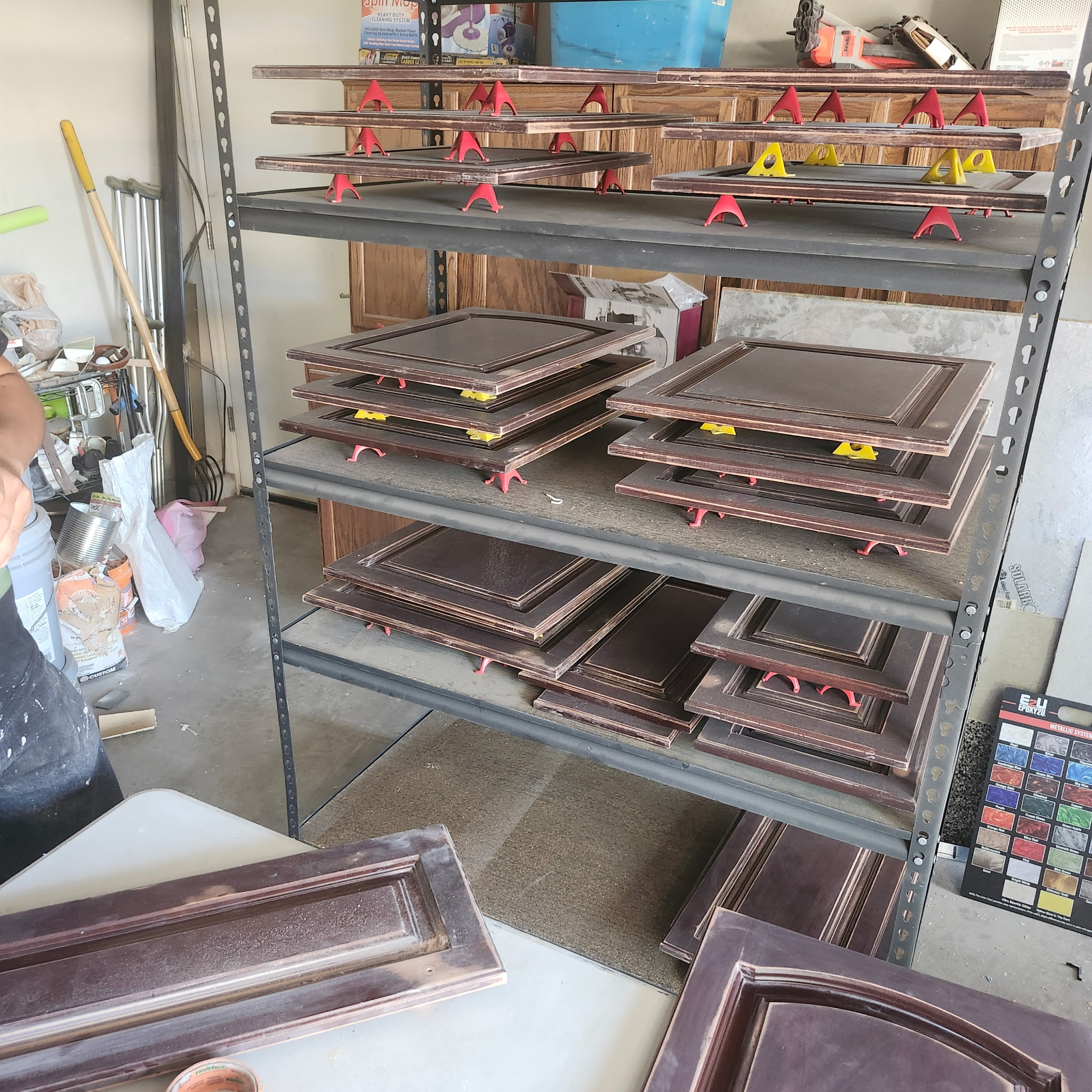 Cabinet doors before refinishing, dark stained wood