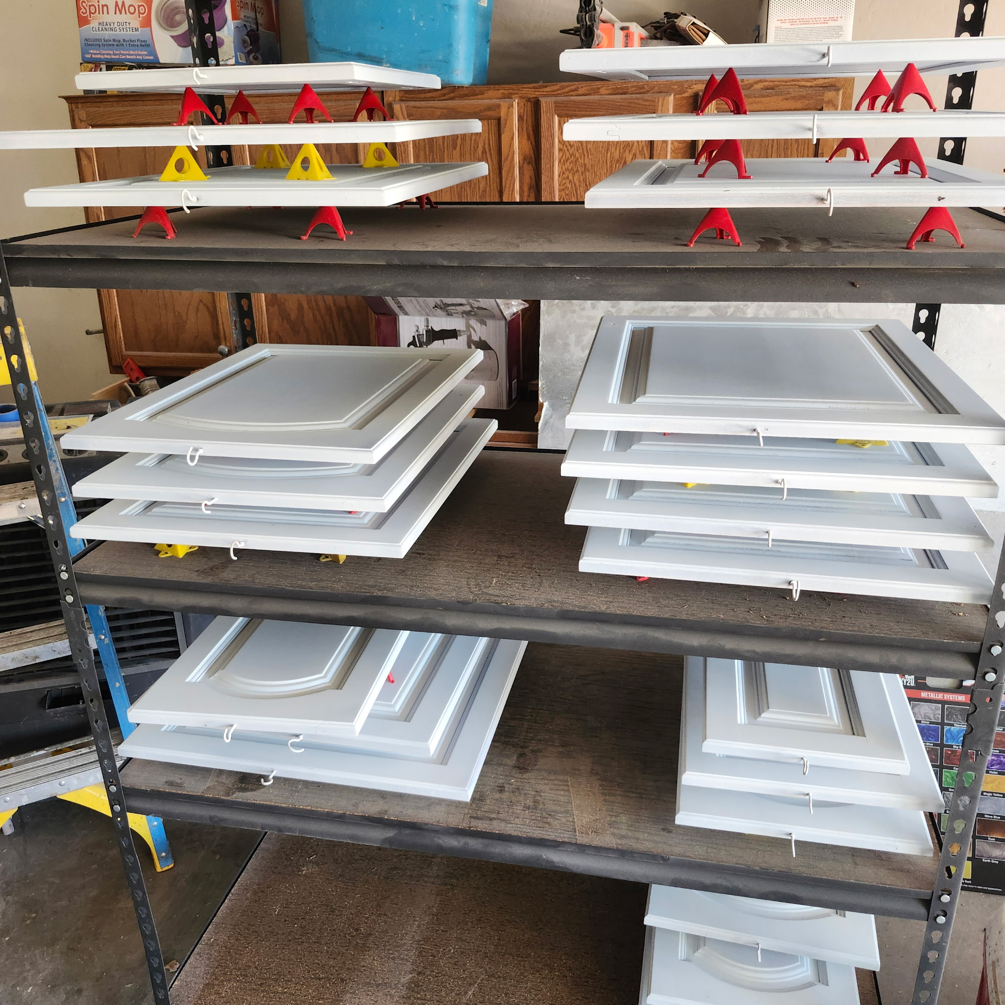 Cabinet doors after refinishing, painted a clean white