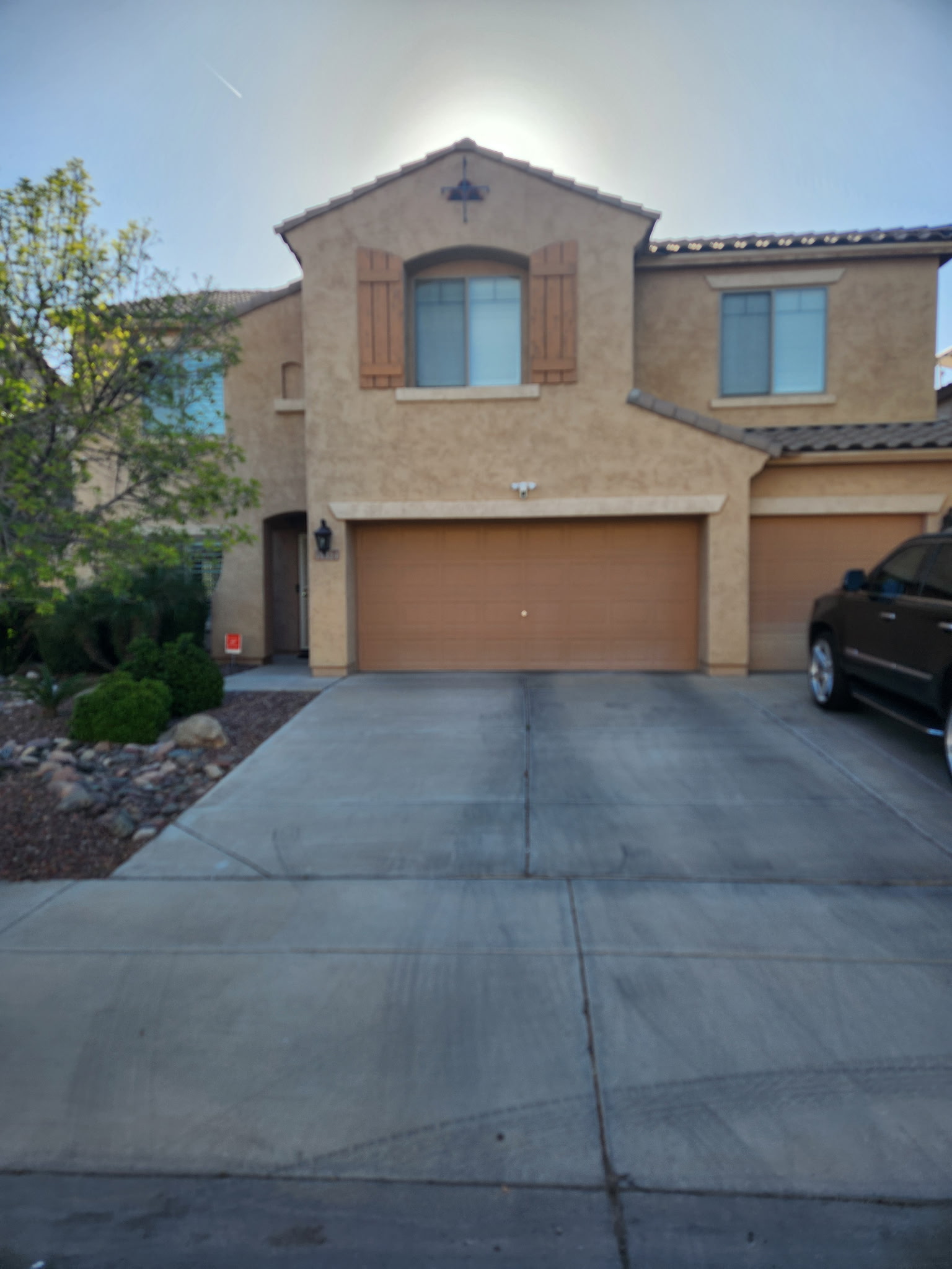 Home exterior before repaint, dusk lighting