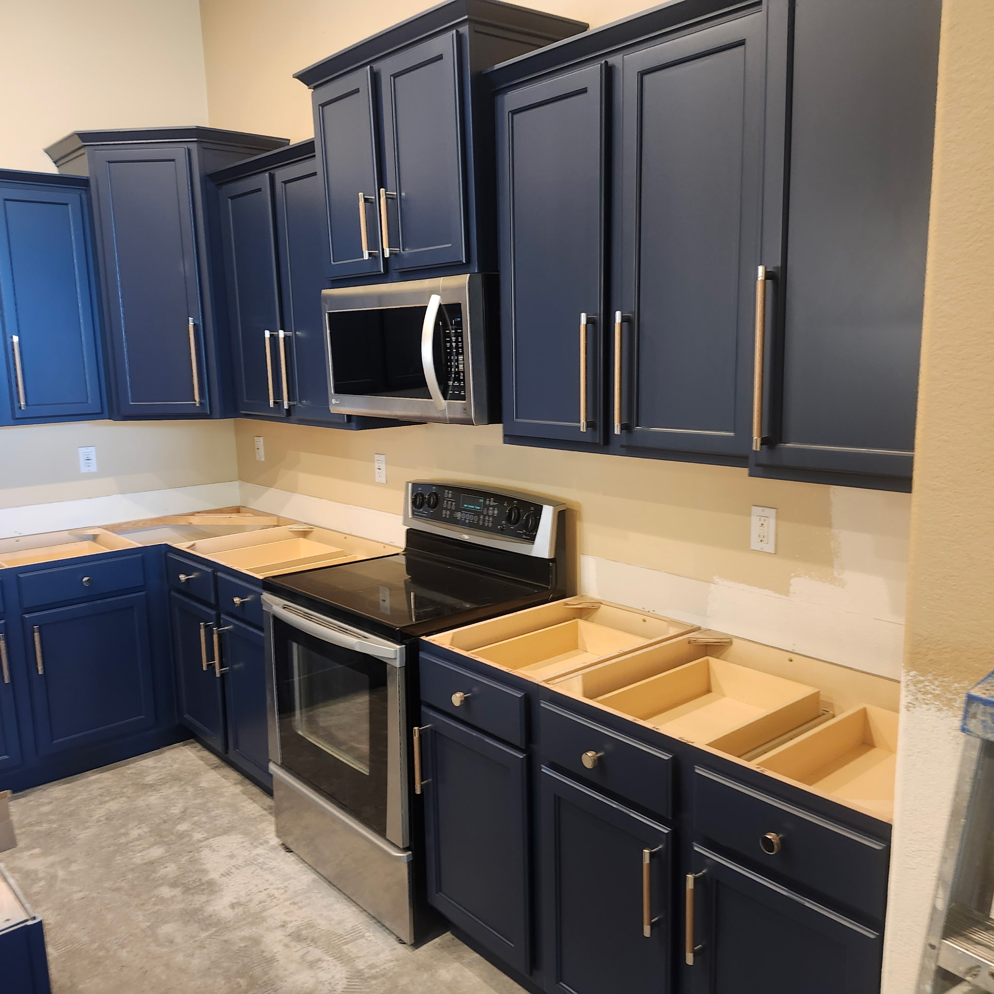 Finished navy blue kitchen cabinets, wide view