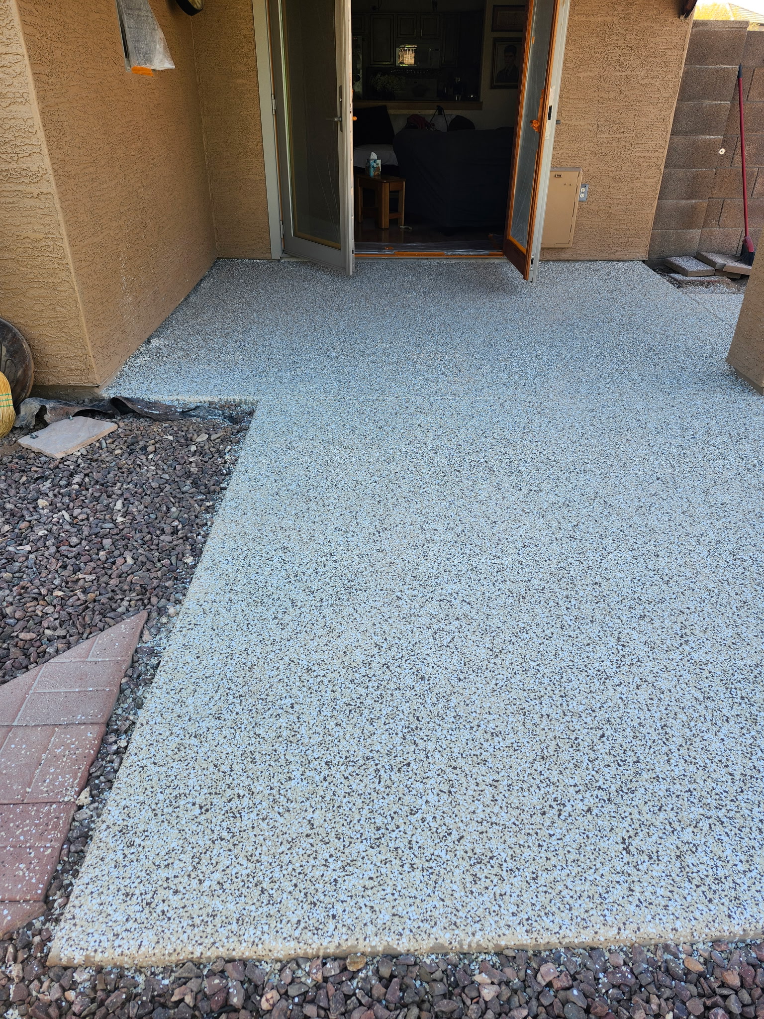 Speckled flake floor coating, wider patio shot near a back door, after